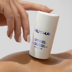 Close-up image of a model balancing the MUTHA Deodorant on the shoulder