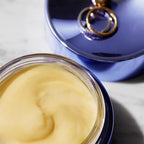 Stylish image of an open jar of Body Butter with a ring on the top