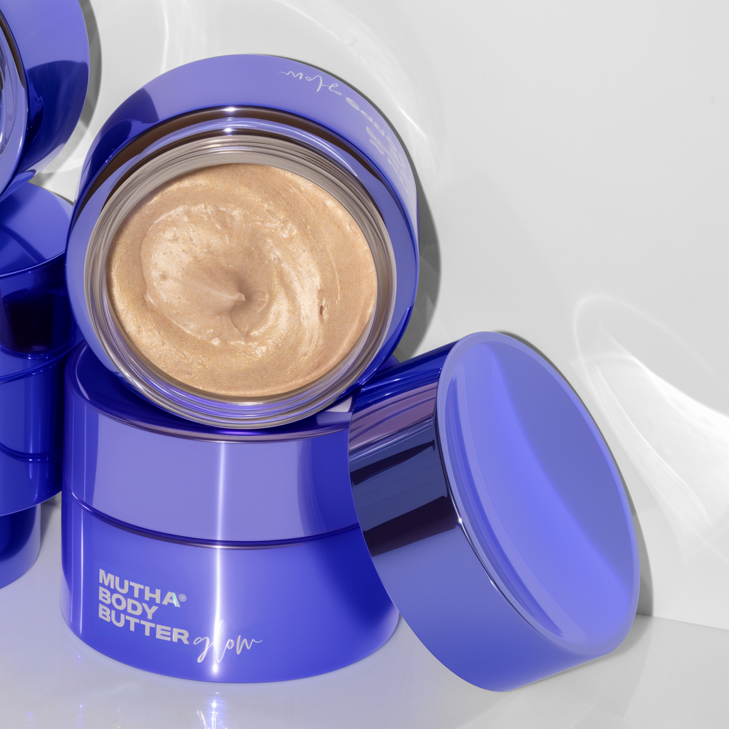 Image of Body Butter Glow jars stacked on top of one another, with the jar on top opened to show product texture
