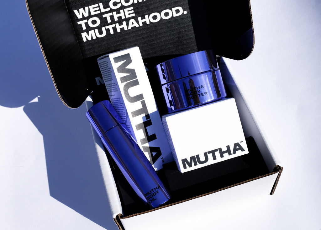 Image of the Body Butter and Body Oil with their secondary packaging displayed inside of a white MUTHA box