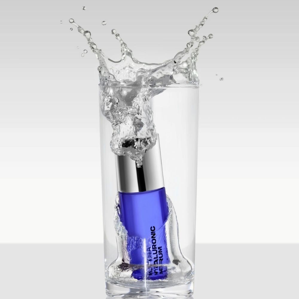 Hyaluronic Serum bottle being submerged in water with a splash effect on a white background