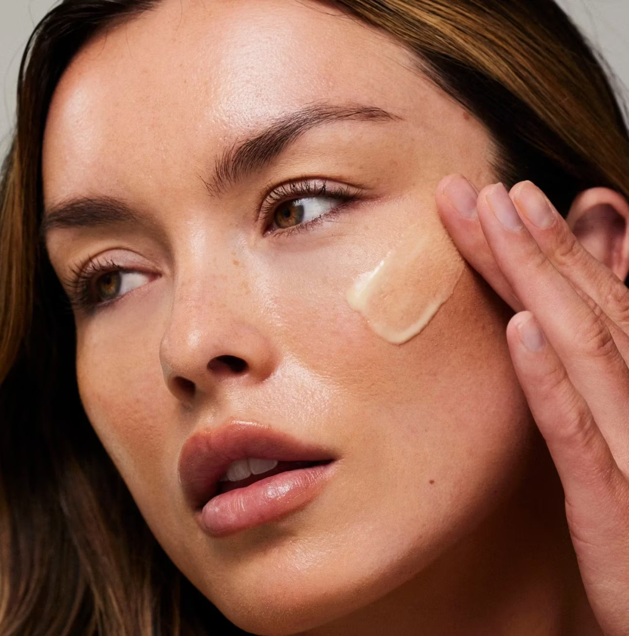 model applying No. 1 Serum to her cheek