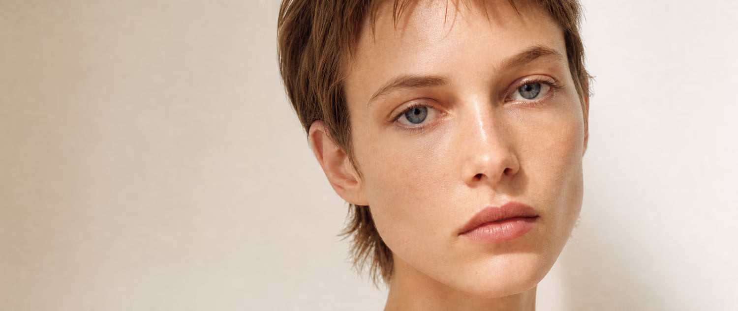 Close-up skin detail, morning light. Model — minimal makeup, well-rested energy.