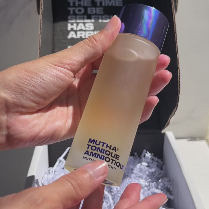 application of the MUTHA Amniotic Toner on model's face using a cotton round