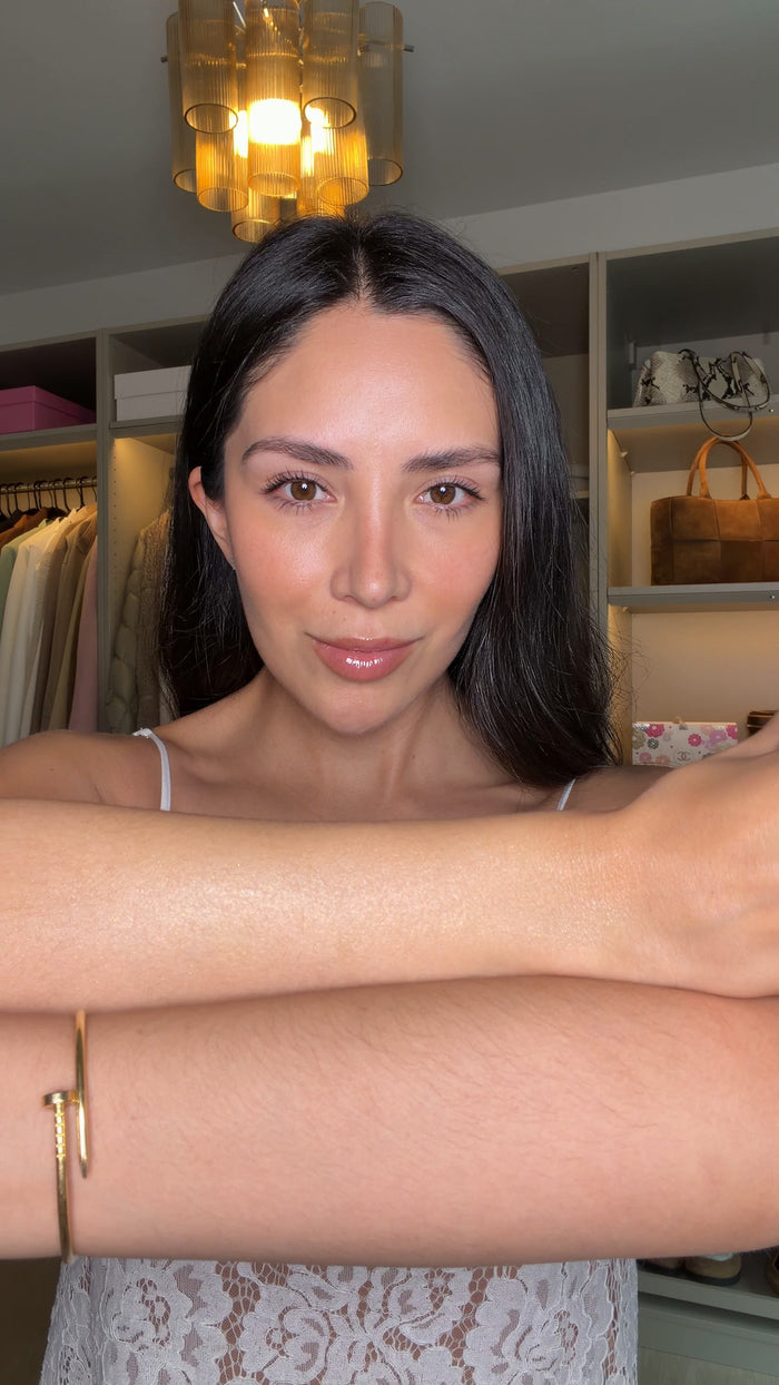 Creator applying MUTHA Body Butter Glow to her forearm.