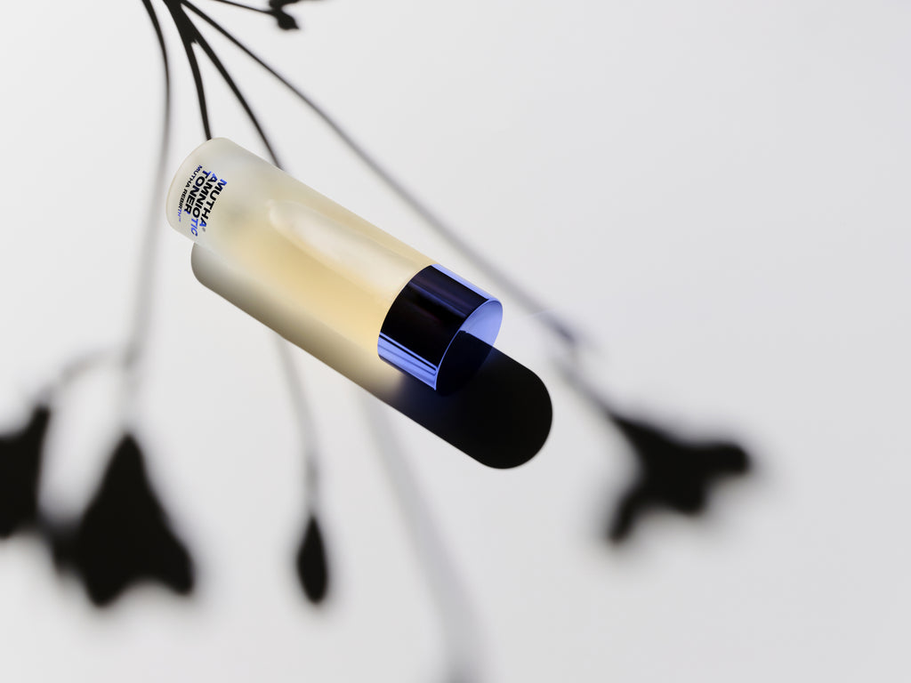 Image of the Rebirth Amniotic Toner with the shadow of a flower above